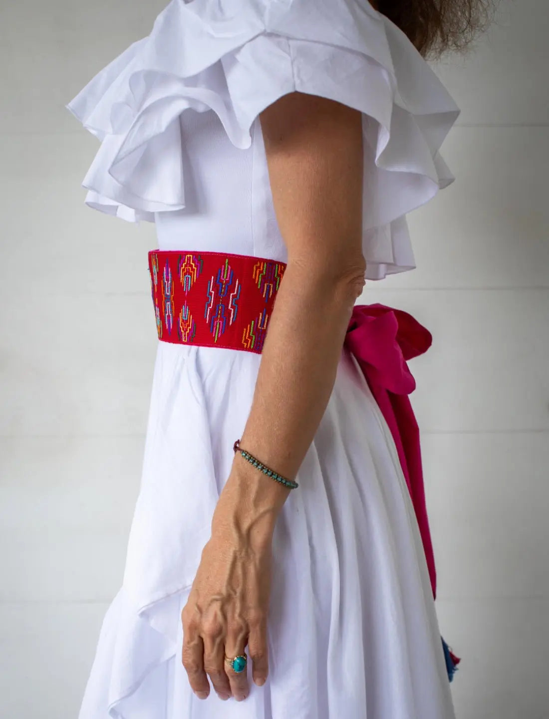 Timar Varja Vibration Red Multicolored Belt styled over a white Spirit Skirt and White Spirit Flower bodysuit by Earth Wisdom Collection